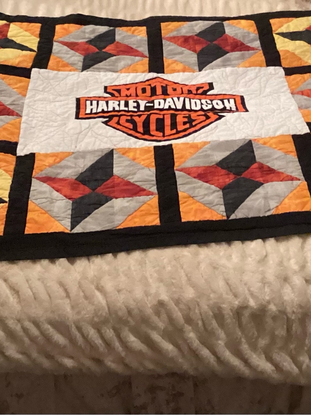 custom Harley-Davidson quilt features a central brand logo